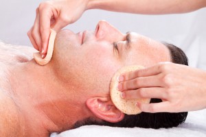 man receiving facial treatment at spa
