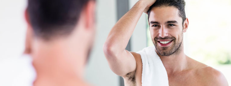 Attractive Man Looking at Reflection in Mirror