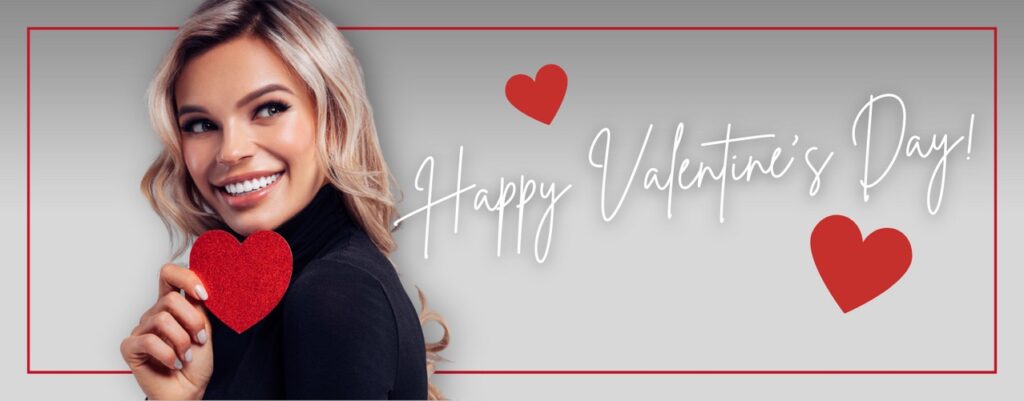 Woman smiling holding a red heart