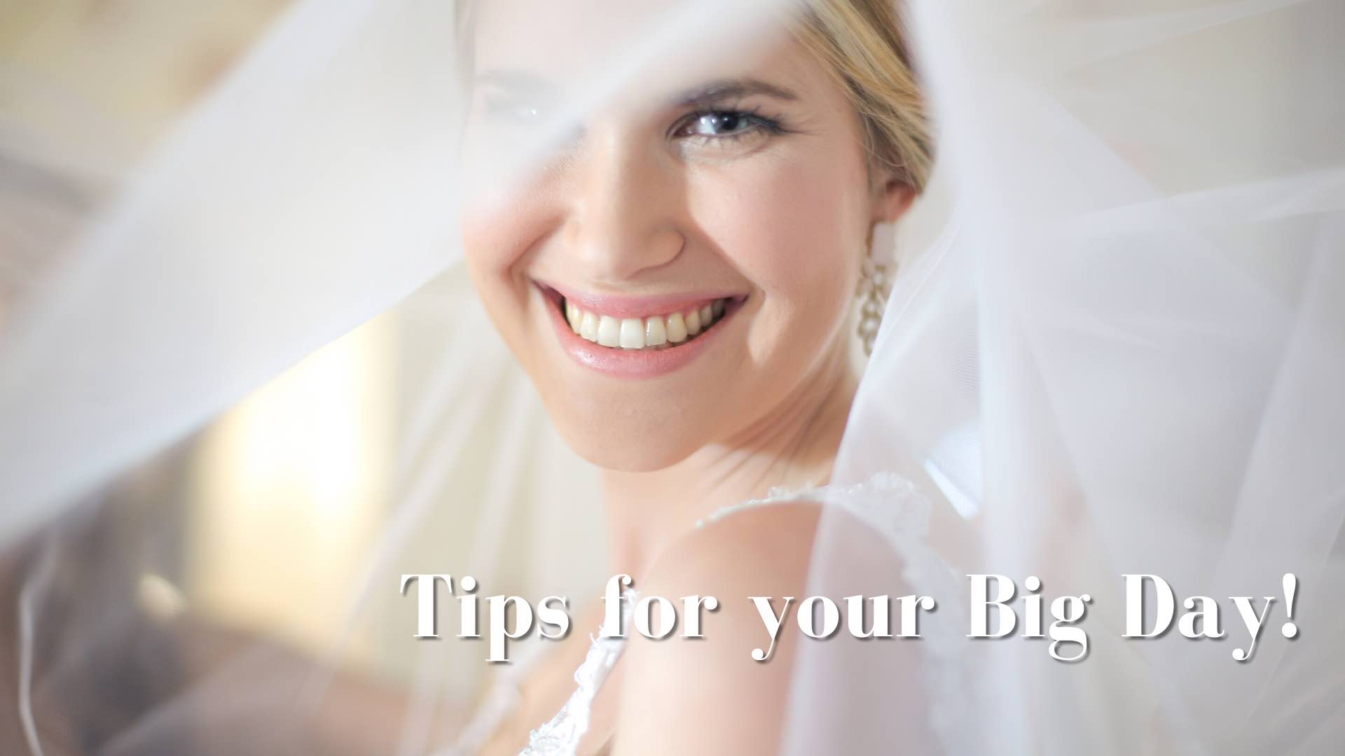 beautiful woman in veil and wedding dress smiling