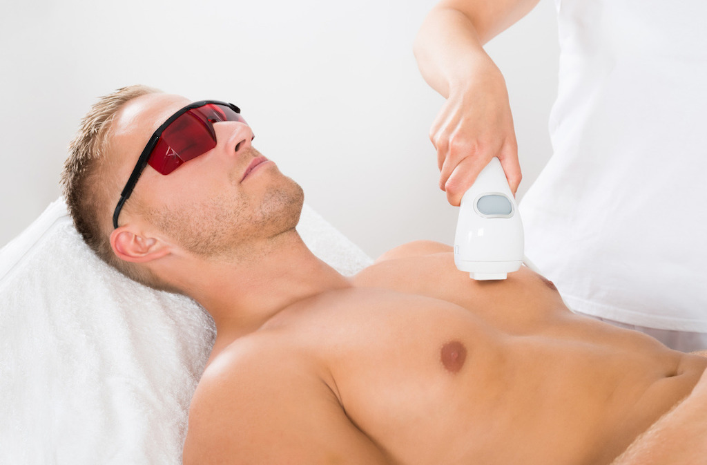 male getting laser hair removal treatment on chest